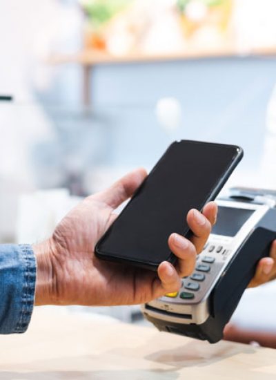 Mobile transaction between customer and employee at the cash register.